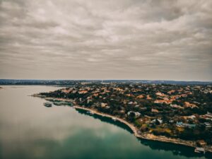Aerial view of Austin Texas neighborhood with buildings and trees near Lake Travis