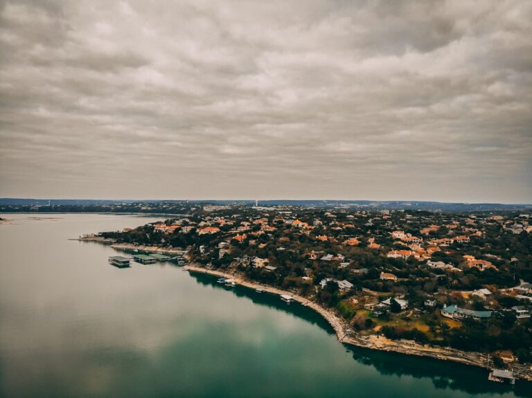 Aerial view of Austin Texas neighborhood with buildings and trees near Lake Travis