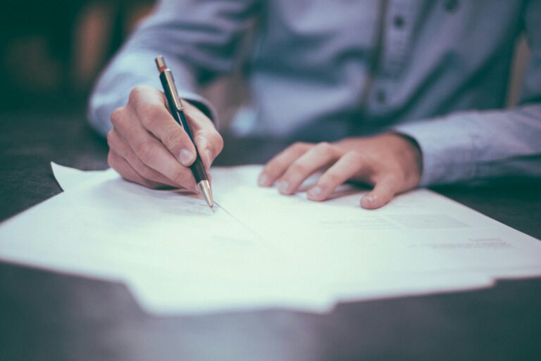 Person reviewing mortgage closing documents at a desk, representing the Texas closing disclosure process