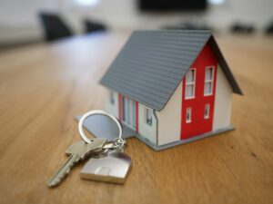 Miniature house model with keys representing Austin FHA home purchase