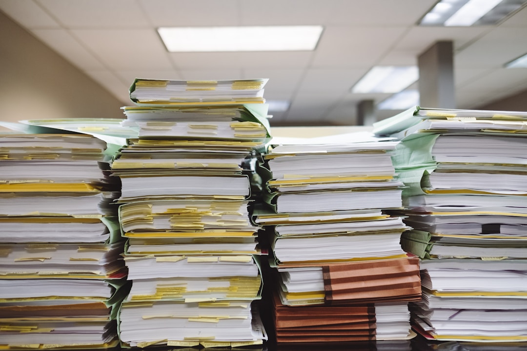 Stacks of paper documents and file folders representing mortgage paperwork