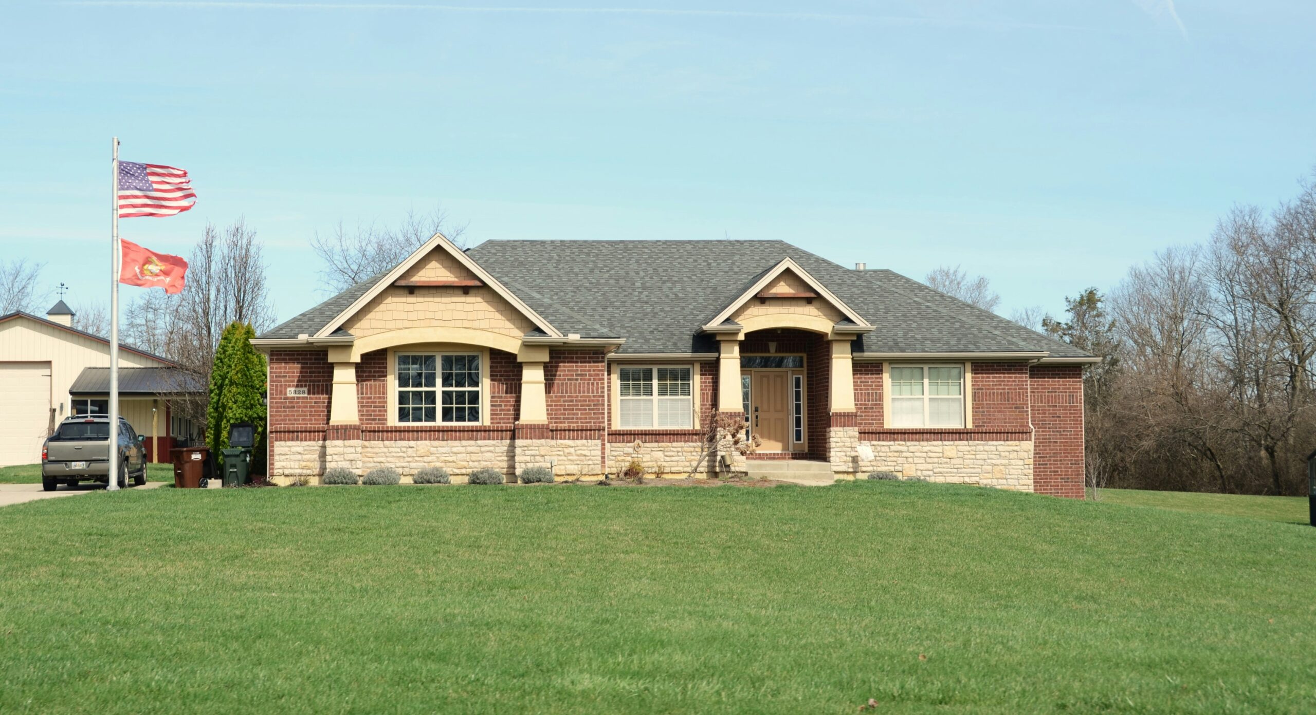 Modern brick house with green lawn representing VA loan home purchase opportunity in Texas