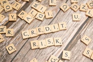 Tiles spelling credit and risk, illustrating how credit score affects an Austin mortgage rate