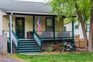 American flag on the front porch of a home, illustrating the VA funding fee for Austin veterans