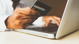 Austin homebuyer reviewing credit card statements on a laptop before a mortgage application
