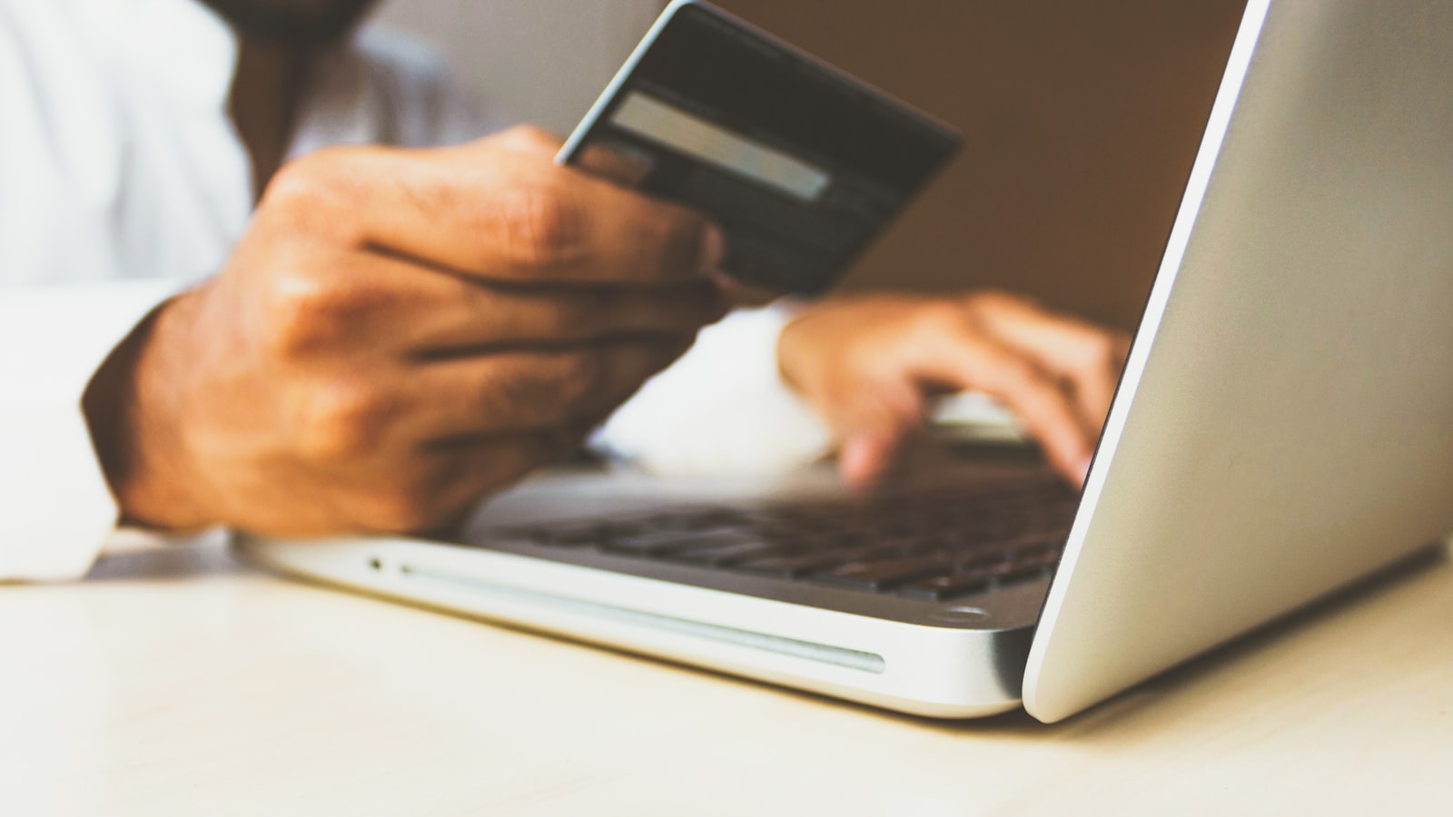Austin homebuyer reviewing credit card statements on a laptop before a mortgage application