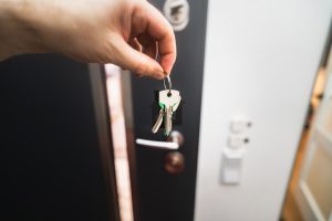 House keys on a table, representing one spouse keeping the home through a divorce home buyout in Austin