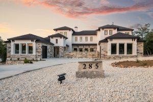 Large modern luxury home at sunset in the price range where Austin buyers weigh jumbo loan myths against conventional options