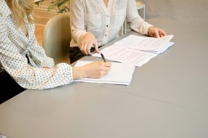 Austin homebuyer signing a written buyer representation agreement with a real estate agent