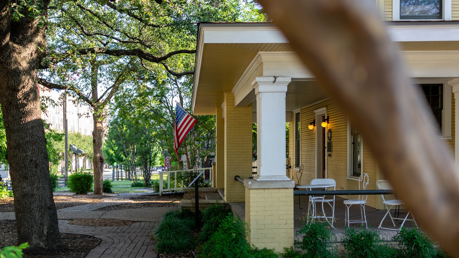 Texas home with front porch and American flag, the kind of primary residence that qualifies for the Texas homestead exemption