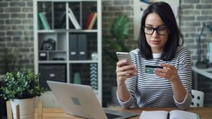 Austin homebuyer reviewing bank account statements on a laptop during liquid asset verification