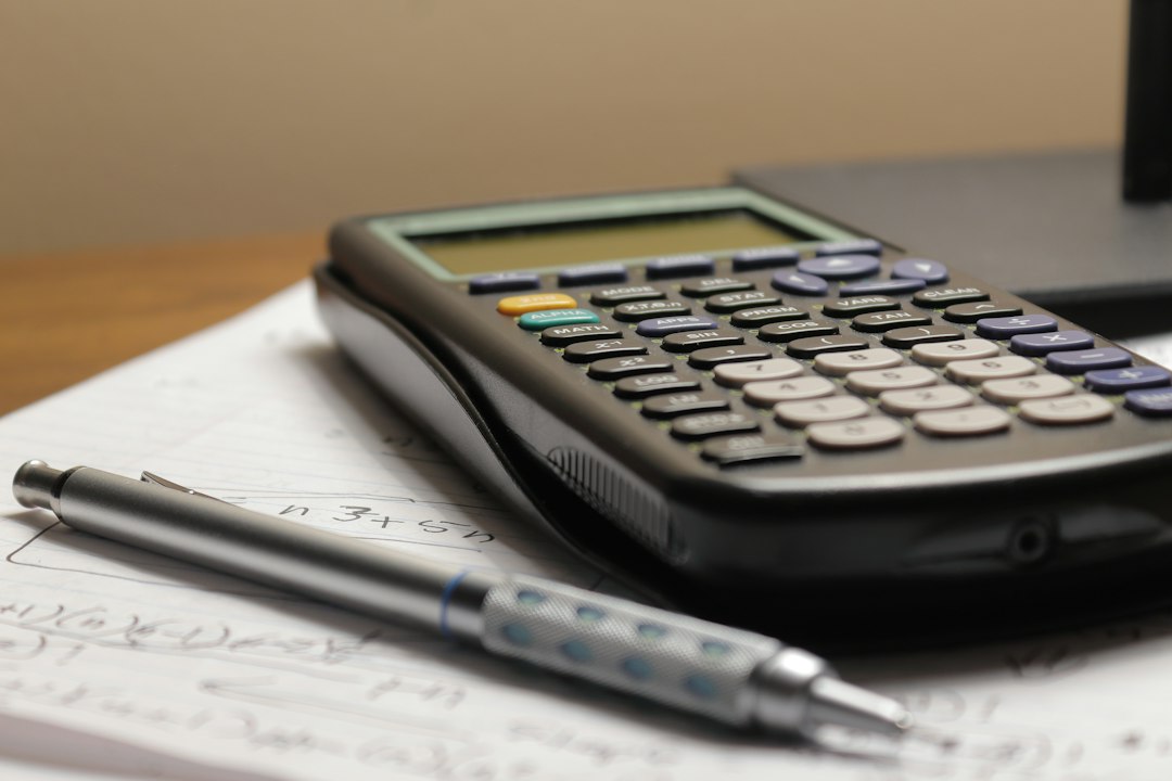 Calculator and mortgage rate sheet on a desk illustrating negative points and lender credits for Austin borrowers