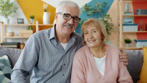 Retired couple reviewing retirement income mortgage documents at a kitchen table