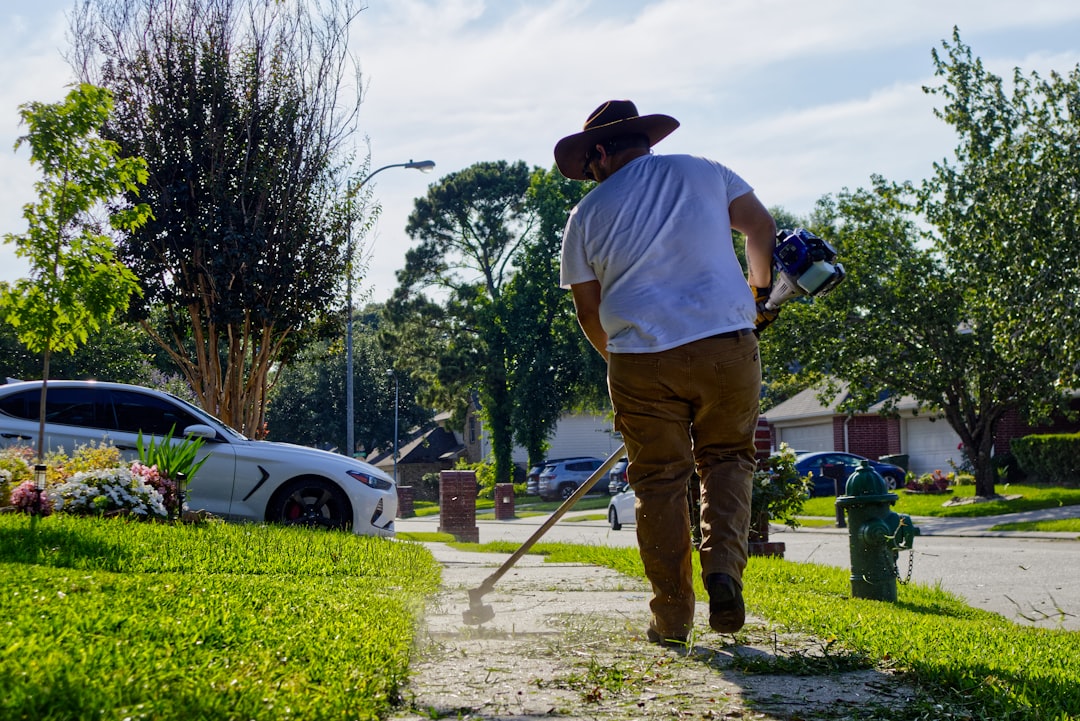 Land surveyor measuring the boundary of a suburban Austin-area home lot